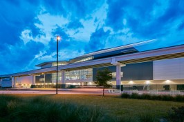 The building's south facade provides an enticing view into the central 'hub' from both approaching vehicular traffic and the adjacent elevated people mover.