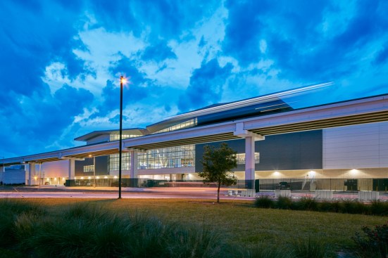 The building's south facade provides an enticing view into the central 'hub' from both approaching vehicular traffic and the adjacent elevated people mover.