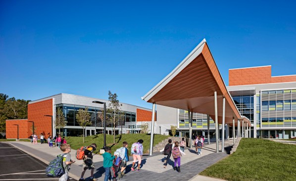 Canopy provides weather protection at the bus drop-off.
A spine of pavers draws students into the three story atrium.