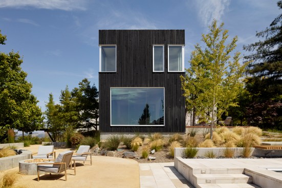 The two-story addition is clad in shou-sugi-ban (burnt Japanese wood).
