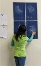 A student at the California Lighting Technology Center at the University of California, Davis, reviews her luminaire design concept as part of a winter 2010 lighting design studio.