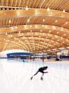 The roof of the Richmond Oval is made up of large Douglas fir glulam arches, with ribbed panels made from recovered wood devastated by a pine beetle infestation in the interstitial spaces.