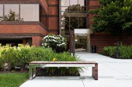 Duo Bench shown with Polished Stainless Steel frame and FSC 100% Jatoba hardwood slats and end at 80 Williams Street, Wellesley, Massachusetts