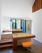 The master bathroom includes a free-standing makeup counter and extra-small mosaic tiles that are warmed by hydronic radiant heating.