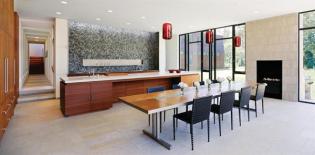 More cook-in dining room than eat-in kitchen, this shared space conceals equipment and food storage behind flush red cedar panels and in stacked cabinets that hide in plain sight.