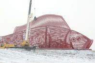 Chinese workers are building a giant steel carp in preparation for the 2015 Harbin Ice and Snow World in Harbin city, northeast China's Heilongjiang province. The fish, 40 meters long, 10 meters wide and 13 meters tall, will feature an ice slide inside to entertain visitors and will be applied by the organizer for a Guinness World Record as the world's biggest steel-made carp.