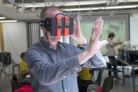 Smartgeometry director Shane Burger wears a modified Oculus Rift to immerse himself visually within a 3D augmented reality.