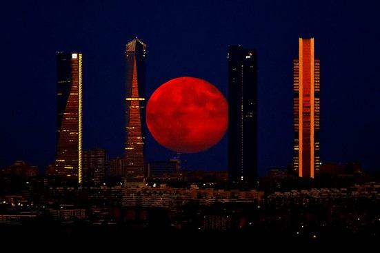 The moon over the Cuatro Torres Business Area in Madrid, Spain, on Monday.