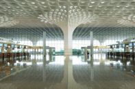 For the 4.4-million-square-foot Terminal 2 at Chhatrapati Shivaji International Airport, in Mumbai, India, Skidmore, Owings & Merrill designed a moment-resisting steel-truss frame that is softened by thousands of precision-made glass-fiber- reinforced concrete panels and gypsum panels.
