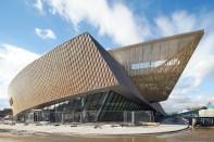 The Centre de Congrès à Mons has a spiraling floor plan and building skin. Construction of Mons Station, designed by Santiago Calatrava, FAIA, is underway on the surrounding site.