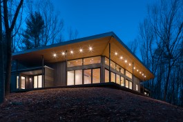 The angled roof enhances the glow of the lantern and creates a unified gathering space for the clients and their guests