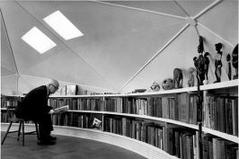 Buckminster Fuller in the loft, which featured a built-in, curved bookcase.