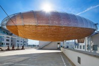 Gulliver cantilevers over the DOX Centre for Contemporary Art, in Prague