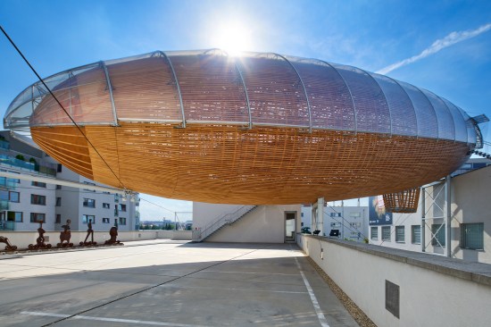 Gulliver cantilevers over the DOX Centre for Contemporary Art, in Prague