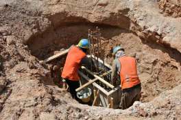 Workers installing pier and beam foundation repairs.