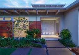 The entry is perpendicular to the street for privacy and is accentuated by an up-lit cast concrete tile wall representing coral reef, to embrace the owner’s passion for the ocean. A horizontal Ipe rain-screen provides an accent and grounds the house.