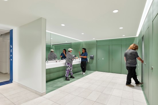 Finished in a palette of calming shades, durable tile flooring, and fixtures from American Standard, Elkay, Bobrick, and Koala Kare, each restroom comprises 11 individual stalls.