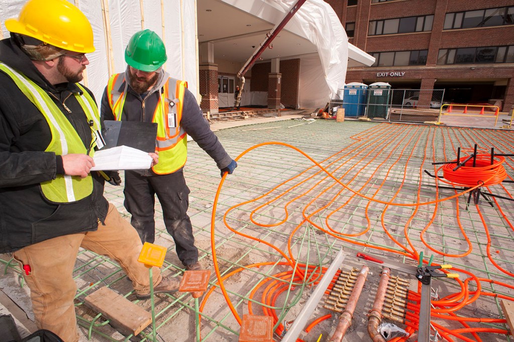 Snowmelt installers review the circulation layout for hydronic tubing as they complete their work prior to a concrete pour at York Hospital in Pennsylvania. Photo courtesy Watts.