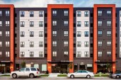 The custom wood grain finish on the façade of the Mino-Bimaadiziwin Apartments reflects the cultural link between the Red Lake Reservation and Minneapolis’ American Indian Cultural Corridor.