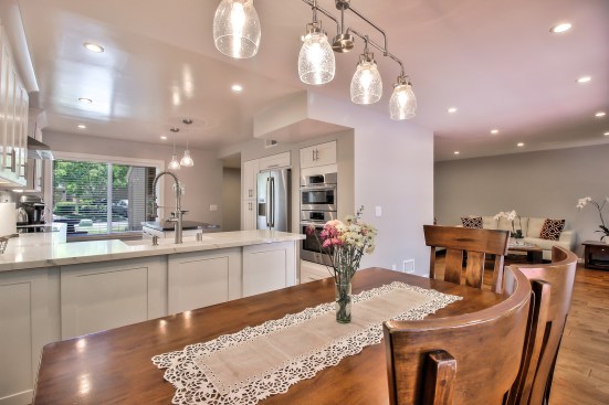 White shaker cabinet, Open space kitchen with quartz counter top. 
Wood flooring 