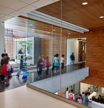 A glass bridge and transparent media center nook overlooking the lobby evoke an environment where education is always happening.