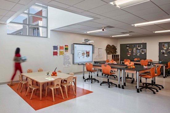 Art Classroom. Flexible seating affords students the opportunity to manipulate the space in a way that supports their collective work. Natural light, understood to enhance learning, transfuses the classrooms. Dual purpose light monitor allows natural light during the day and serves as a light beacon at night for evening events.