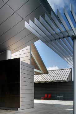 A palette of modern, natural materials such as zinc, grey granite, maple, and light colored metal offer durability and warmth to the indoor and outdoor spaces.