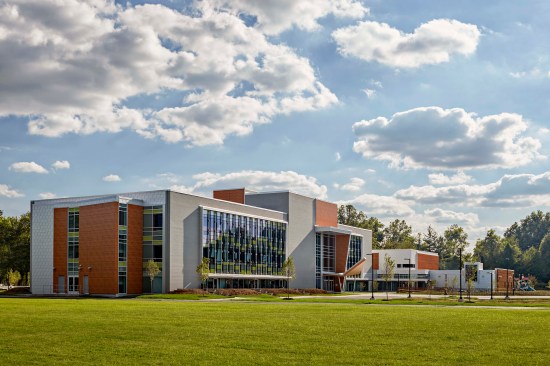 Double-loaded corridors have vanishing points that look out onto the wooded site so that there are no “dead ends.” Canopies serve double duty collecting rainwater into rain barrels. Exterior shell and curtain wall designed to reflect light, mimics the movement of cars on the nearby Berlin Turnpike. The property includes ball fields and playscapes, which are utilized by community residents as well as the school, creating a 24 / 7 environment.