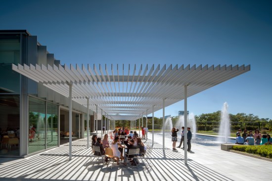 A broad trellis acts as a porch providing places for gathering and a transition between the Pavilion and garden.
