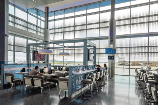 Lounge-style holdrooms feature tablets and various seating and table arrangements for passenger comfort. The custom frit pattern on the exterior glazing provides sun protection without obstructing the views.