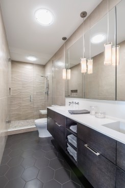 Modern bathroom with long wall mounted vanity and walk-in shower