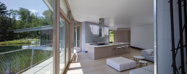 The open kitchen features a La Canache stove with a hood from Zephyr and cabinets by Tim Cook. Venetian plaster on the walls throughout the house was applied by Ron Decavalcanti.