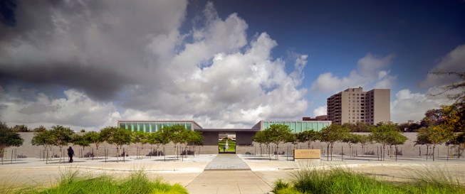 The Pavilion and garden entrance is aligned with the site's east-west axis. To lantern-like volumes project above the site wall creating an inviting and measured entry.