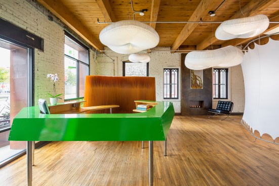 Front desk of chiropractor's office with custom green metal desk