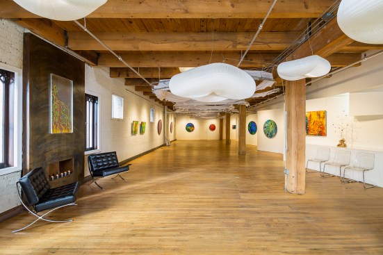 A large event and gallery space that can be converted to a working chiropractor's office by lowering cloth pods - pods are raised in this photo