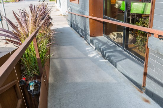 Handicapped accessible ramp with artistic corten steel railing and planter