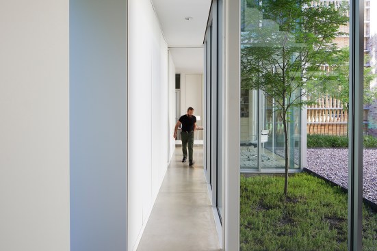 Polished concrete and zero-VOC paint from AFM Safecoat line the floors and walls of this glazed corridor connecting the office to the open living area. 