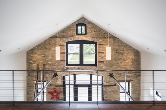 View from loftspace down to entrance and original brick wall