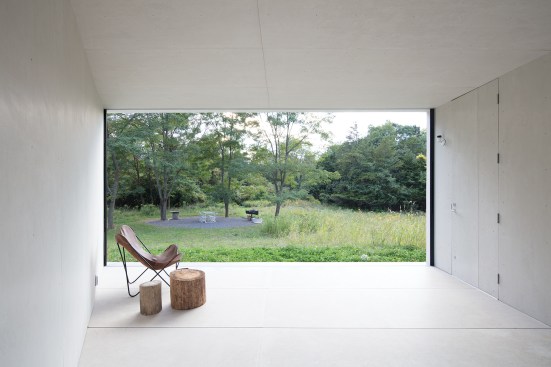The interior porch on the ground floor looks over one of the outdoor living spaces created with local crushed stone.