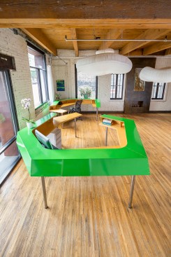 Custom green metal desk in chiropractor's office seen from above