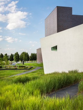 View from the top of the new hill on site—part of the extensive landscape design by Inside Outside—with the Herzog & de Meuron addition in the foreground, the re-clad Edward Larrabee Barnes building beyond, and the green roof of the new HGA addition to its left.