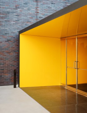 The yellow metal walls and ceiling of the new entry vestibule draw in visitors, and were part of an effort “not of making it art, per say, but to take it almost out of the realm of being architectural,” Cook says. “You don’t normally find this high-gloss paint finish in buildings.”