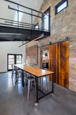Custom table in work area with steel walkway over head