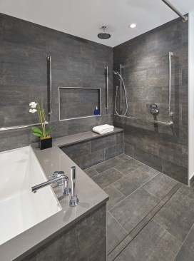 A detail of the shower area, showcasing the linear drain and fixtures.