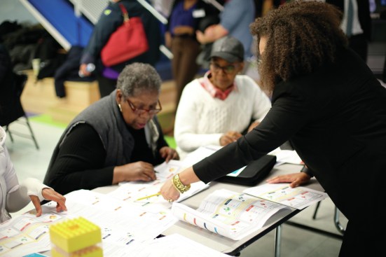 MASS Design Group team leading comunity engagement exercises with residents