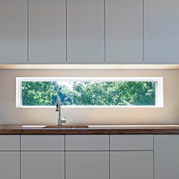 The kitchen cabinets discreetly conceal appliances including an undercounter mini-fridge and freezer.