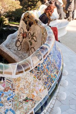 The bench comprises colorful mosaics assembled in the method of trencadis.