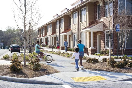 The Village Green site in Rome, Georgia, was designed to create an urban neighborhood feeling. Sidewalks and crosswalks, as well as a park behind the building, connect the apartment community to the surrounding development.