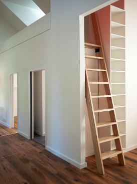 A ladder leads to the open loft area.