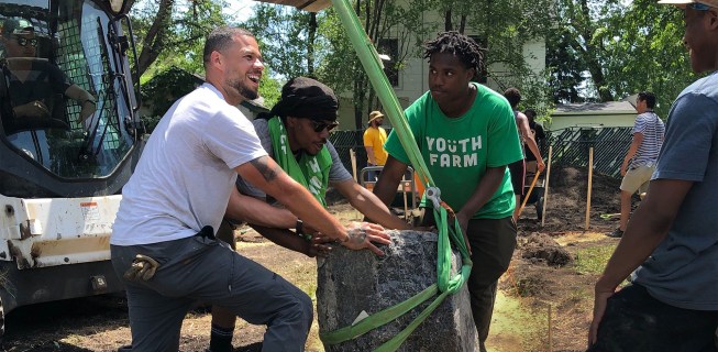 Artist Jordan Weber, left, works with Youth Farm members and the community.
